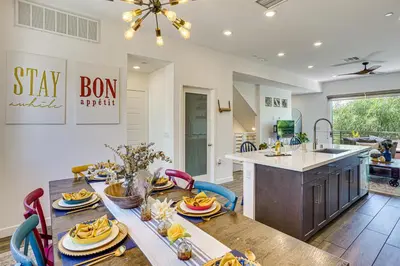 a kitchen and dining room with a table with food at 2 Mi to Cabrillo Beach Luxe LA Gem with Balcony in San Pedro