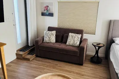 a brown couch sitting in a living room at Coldwater Canyon ADU in Los Angeles