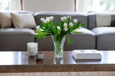 a vase of white flowers sitting on a table at Stylish Penthouse in West Hollywood in Los Angeles