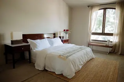 a bedroom with a bed and a desk and a window at Stylish Penthouse in West Hollywood in Los Angeles