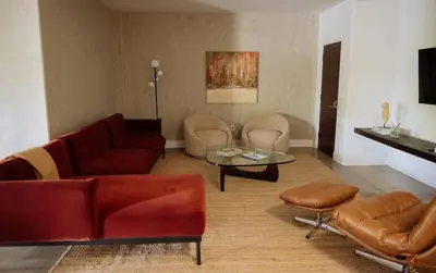 a living room with a couch and a table and chairs at Cozy Charm in West Hollywood in Los Angeles
