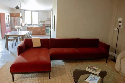 a living room with a red couch and a table at Cozy Charm in West Hollywood in Los Angeles