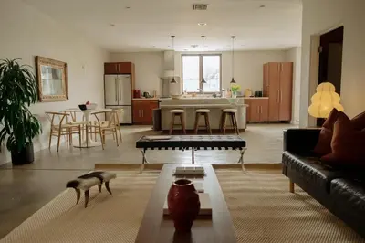 a living room with a couch and a table at Dreamy Mid-Century Modern Pad in Los Angeles