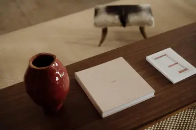 a table with a vase and a book on it at Dreamy Mid-Century Modern Pad in Los Angeles