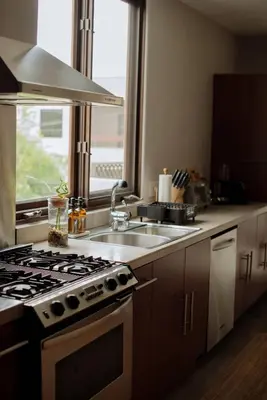 a kitchen with a stove and a sink and a window at Dreamy Mid-Century Modern Pad in Los Angeles