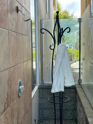 a towel is sitting on a chair in front of a shower at Time2Relax in Oxnard