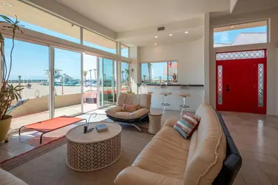 a living room with a couch and a red door at Time2Relax in Oxnard