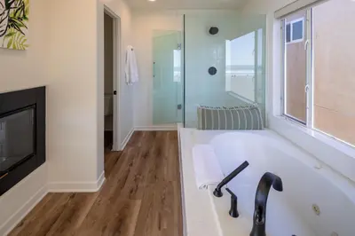 a bathroom with a bath tub and a television at Time2Relax in Oxnard