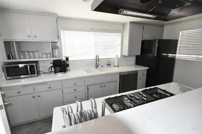 a kitchen with white cabinets and a white counter top at Ocean Blue in Oxnard