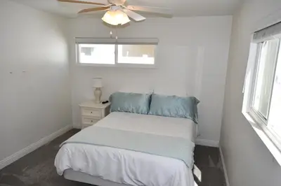 a bedroom with a bed and a ceiling fan at Ocean Blue in Oxnard
