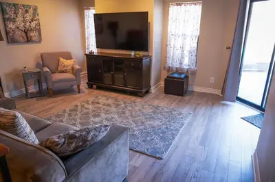 a living room with a couch and a flat screen tv at Surfside Four in Port Hueneme