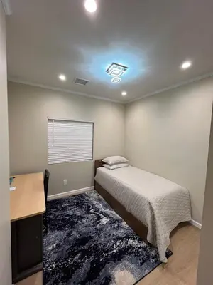 a bedroom with a bed and a desk and a bed sidx sidx sidx at House in Torrance