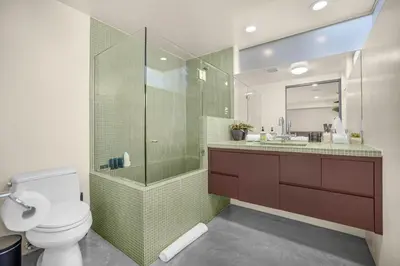 a bathroom with a toilet and a glass shower at Solara Point in Los Angeles