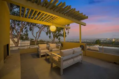 a patio with a couch and chairs on a roof at Solara Point in Los Angeles