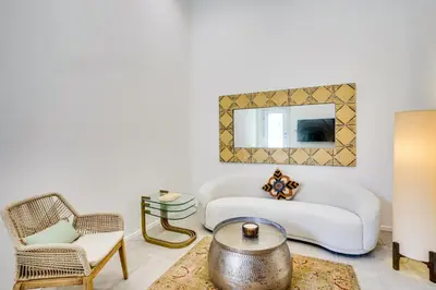 a living room with a white couch and chairs at Shop, Dine and Walk to Ocean Redondo Beach Apt! in Redondo Beach