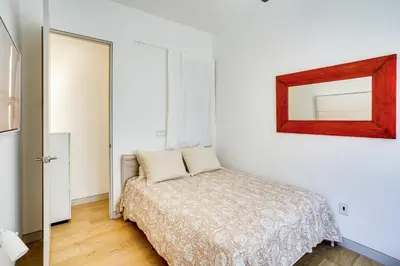 a bedroom with a bed and a mirror on the wall at Shop, Dine and Walk to Ocean Redondo Beach Apt! in Redondo Beach