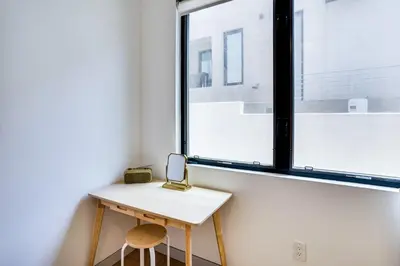a small table and two stools in front of a window at Shop, Dine and Walk to Ocean Redondo Beach Apt! in Redondo Beach