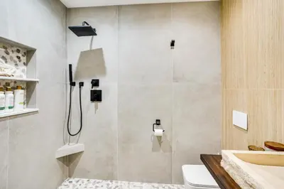 a bathroom with a shower with a sink and a toilet at Shop, Dine and Walk to Ocean Redondo Beach Apt! in Redondo Beach