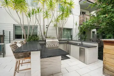 a outdoor kitchen with a counter and a grill at The Amber Serene Peaceful Retreat Pool Gym And Jacuzzi in Los Angeles