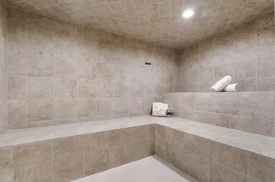 a bathroom with a large shower with tiled walls at Playa Del Sol by Stay Awhile Villas in Malibu Beach