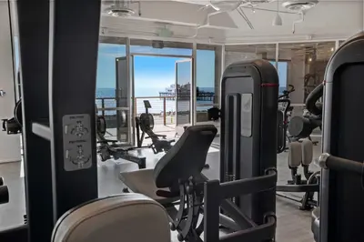 a gym with cardio equipment and a view of the ocean at Playa Del Sol by Stay Awhile Villas in Malibu Beach
