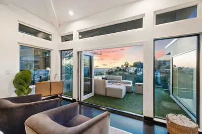 an open living room with glass doors and furniture at Six Senses by Stay Awhile Villas in Los Angeles