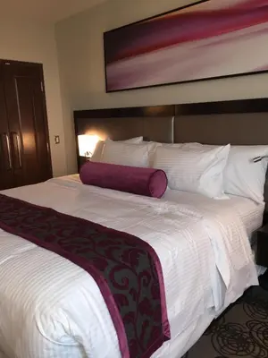 a large white bed in a hotel room at Parkwest Bicycle Casino in Bell Gardens