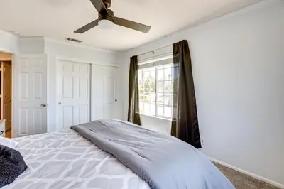 a bedroom with a bed and a ceiling fan at Pool, Spa and Mountain Views Apple Valley Retreat! in Apple Valley