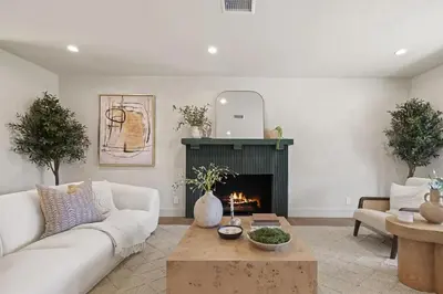 a living room with a couch and a fireplace at The Dona Modern in Los Angeles