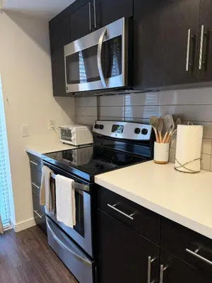 a kitchen with a stove and a microwave at The Hollywood Blvd Loft FREE AND DESIGNATED PARKING in Los Angeles