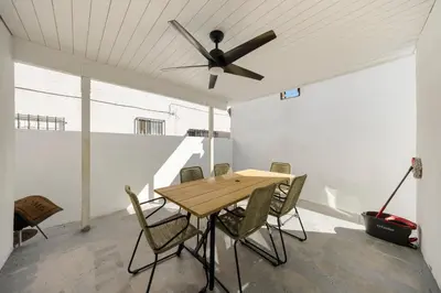 a dining room with a table and a ceiling fan at #Marbella Lane - Cityside Haven with Touch of Charm in Compton