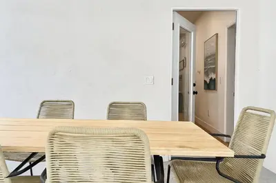 a conference room with a wooden table and chairs at #Marbella Lane - Cityside Haven with Touch of Charm in Compton