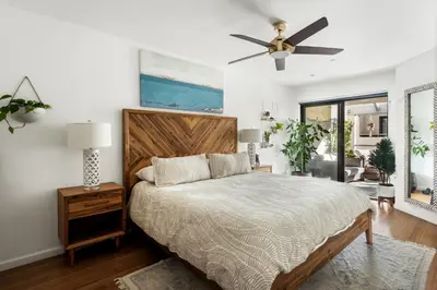 a bedroom with a bed and a ceiling fan at Oceanfront Artists Retreat Santa Monica Luxury in Los Angeles