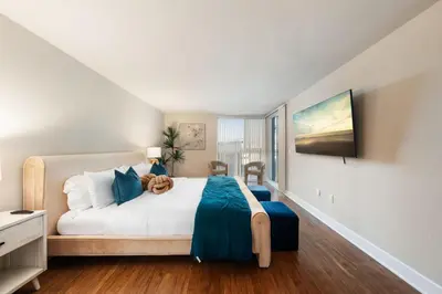 a bedroom with a large white bed and a window at Azure Marina Luxe - Waterfront with Sunset Views in Los Angeles