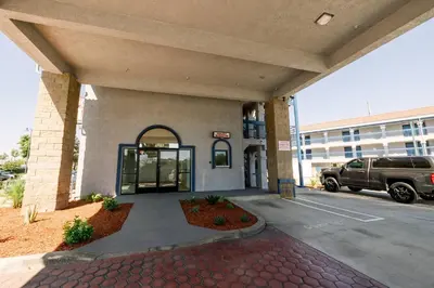 a front entrance to a building with a truck parked outside at Downey Inn in Downey