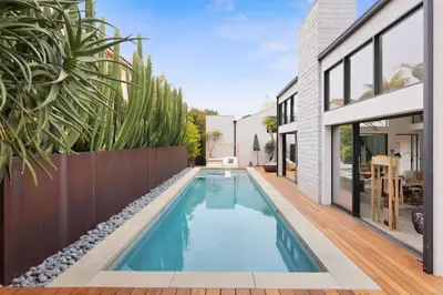 a swimming pool in the backyard of a house at The Colony Reserve by Stay Awhile Villas in Malibu Beach