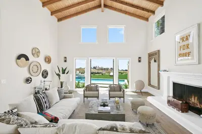 a living room with white furniture and a fireplace at Villa Azure - by Stay Awhile Villas in Malibu