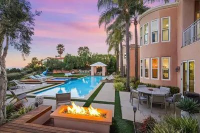 a backyard with a swimming pool and a fire pit at Villa Azure - by Stay Awhile Villas in Malibu