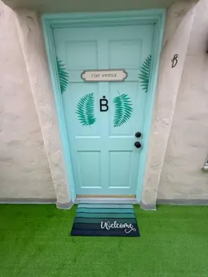 a blue garage door with a welcome sign on it at At Hermosa Ave and Pier ave- B in Hermosa Beach