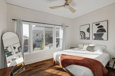 a white bedroom with a bed and a window at At Hermosa Ave and Pier Ave- C in Hermosa Beach