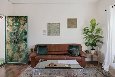 a living room with a couch and a table at At Hermosa Ave and Pier Ave- C in Hermosa Beach