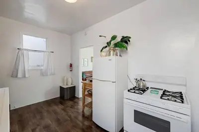 a kitchen with a white refrigerator and a stove at At Hermosa Ave and Pier Ave- C in Hermosa Beach
