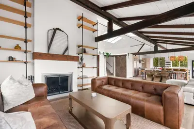 a living room with a couch and a fireplace at New Listing Palisades Villa by Colby & Conrad in Los Angeles