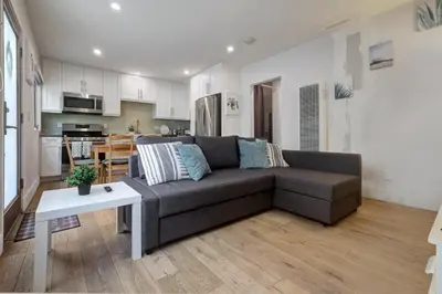 a living room with a couch and a kitchen at Feel At Home At A One Bedroom Apt 1 Block From The Beach in Hermosa Beach