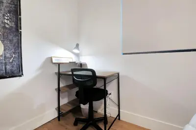 a desk with a chair next to a wall at Feel At Home At A One Bedroom Apt 1 Block From The Beach in Hermosa Beach