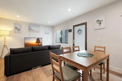 a living room with a couch and a table at Feel At Home At A One Bedroom Apt 1 Block From The Beach in Hermosa Beach