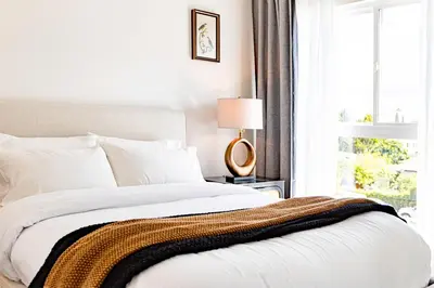 a bedroom with a large bed with a window at Grand 4-Bedroom - Brand New - Free parking and Patio in Los Angeles