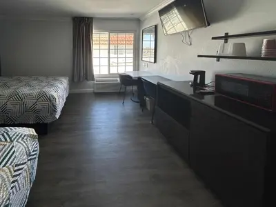 a hotel room with a kitchen and a dining room at Studio 6 Suites Buena Park CA Anahiem Near Maingate Knotts in Buena Park