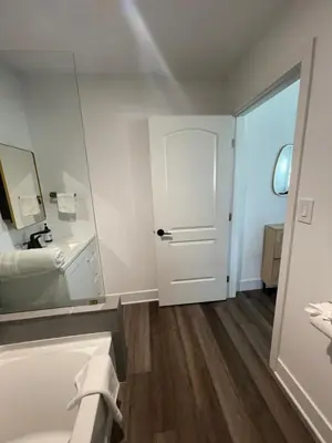a white bathroom with a sink and a mirror at Modern LA Guest House in Los Angeles