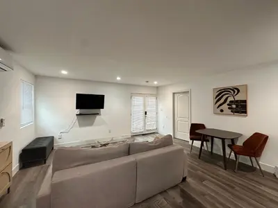a living room with a couch and a table at Modern LA Guest House in Los Angeles